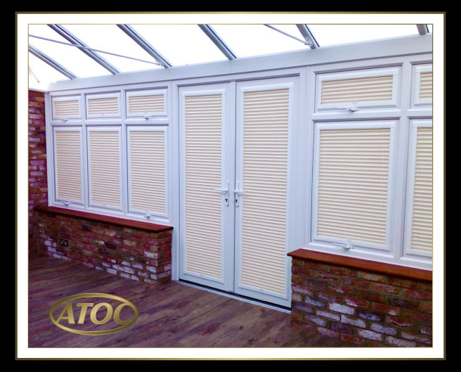 Perfect Fit blinds on uPVC doors and conservatory windows in Essex, keeping access clear and sills clutter free