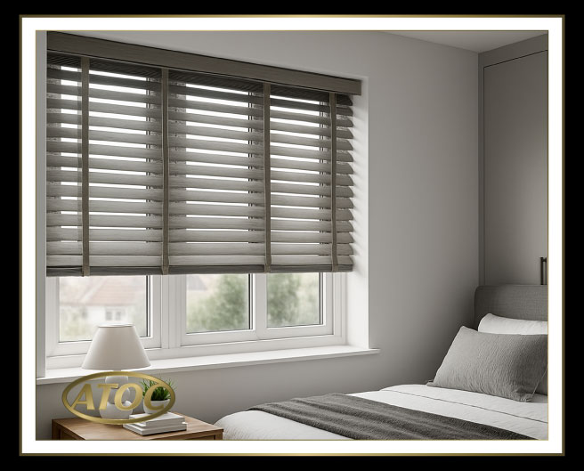 Wooden venetian blinds tilted half closed to maintain privacy while letting daylight in at a street-facing Essex window